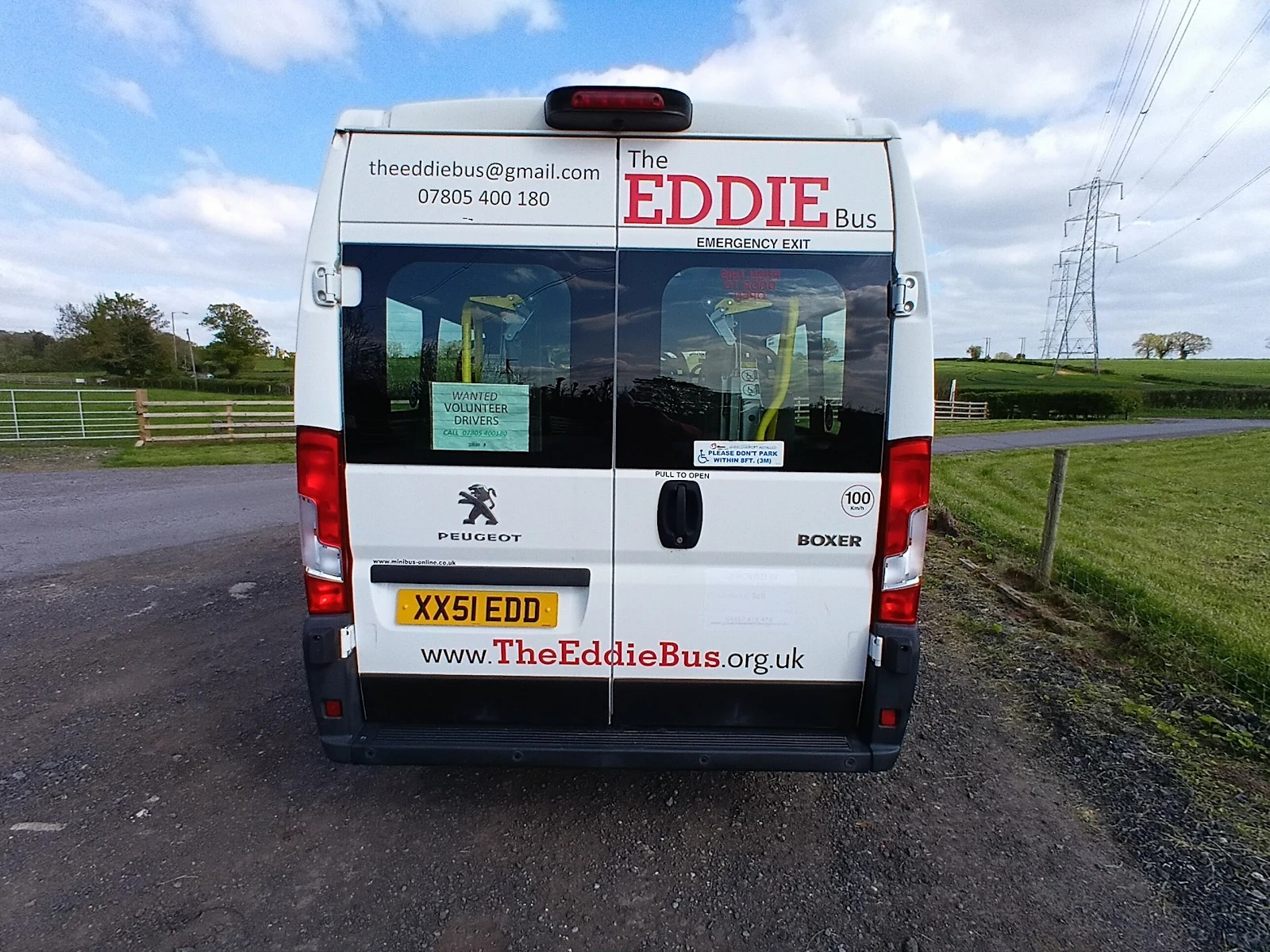 Rear view of The EDDIE Bus with contact details on the doors